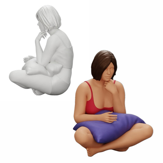 Foto del producto de modelismo de diorama 0: Niña sentada frente al televisor con almohadas en las piernas (Ref Nr. A36)