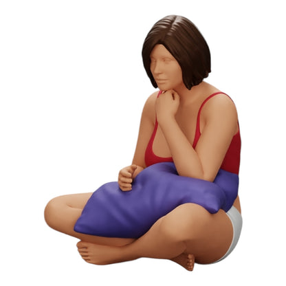 Foto del producto de modelismo de diorama 0: Niña sentada frente al televisor con almohadas en las piernas (Ref Nr. A36)